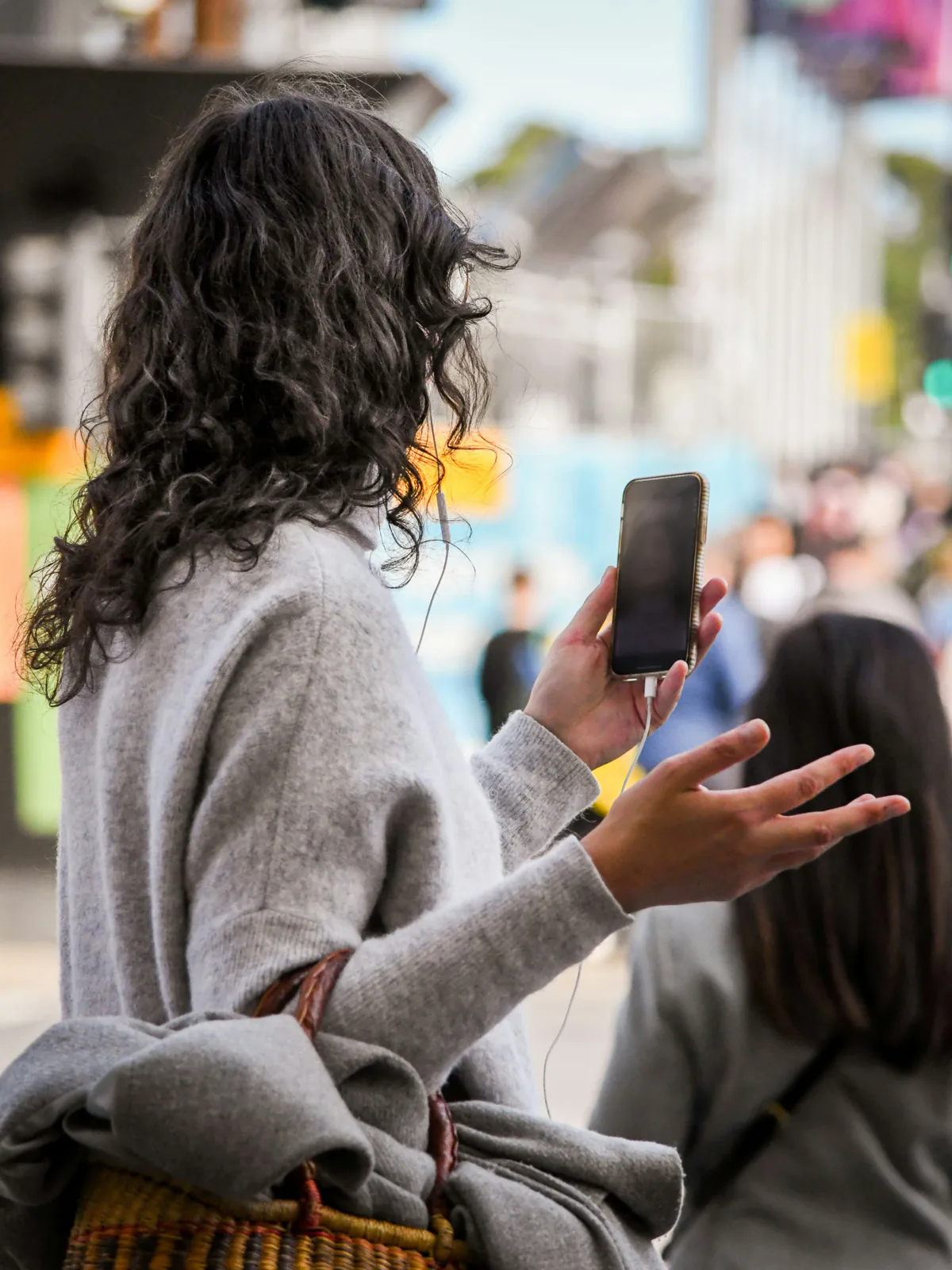 A person walking outside holding a phone