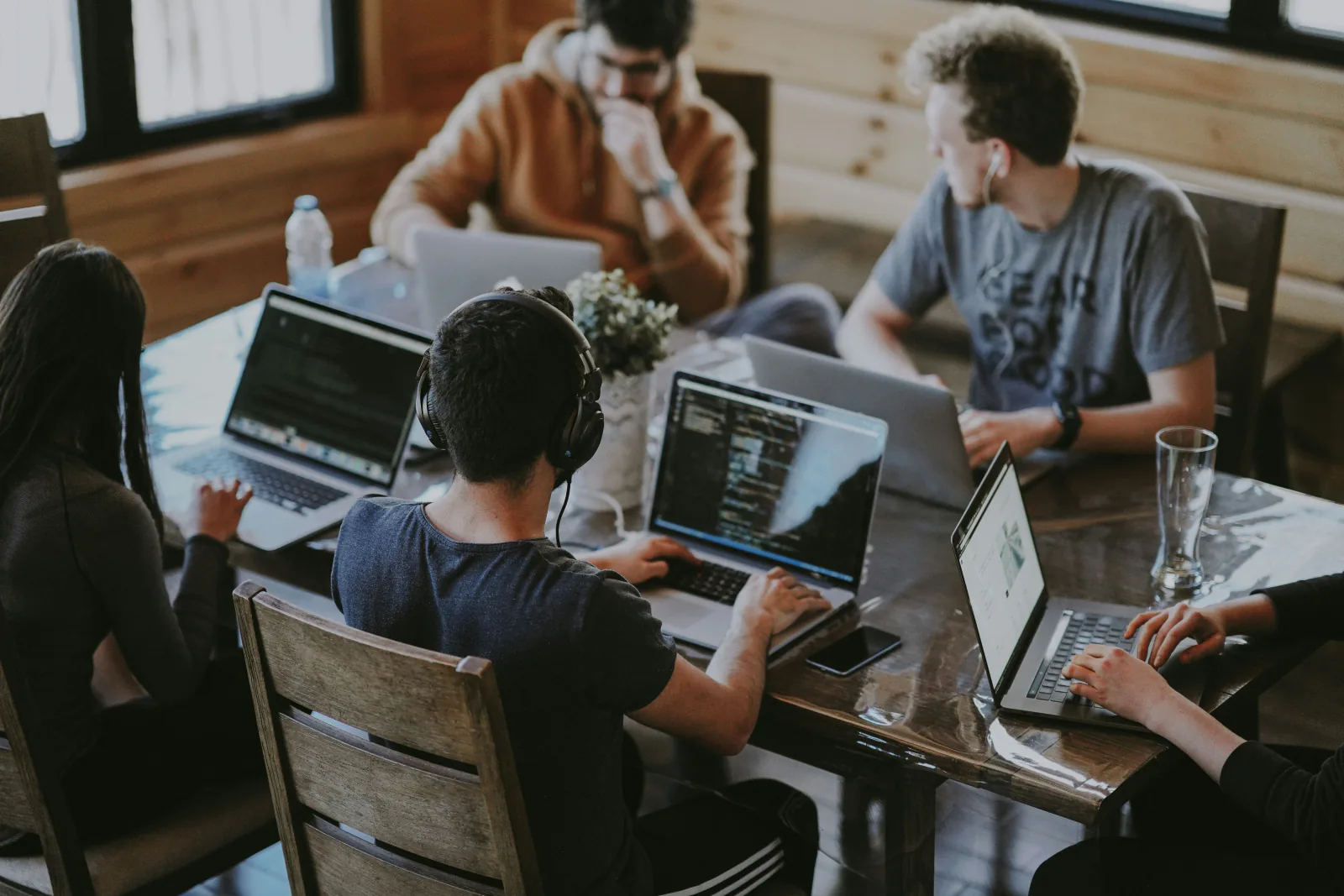 A team working together at laptops around a table
